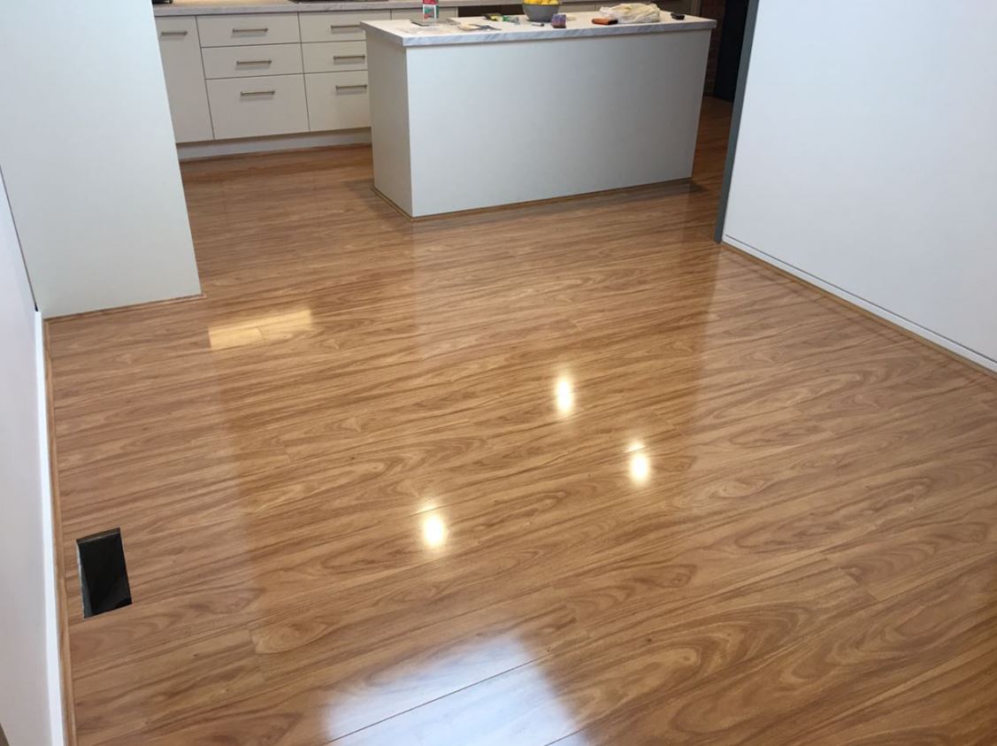 Laminate Blackbutt flooring through an open plan kitchen and living area in a Rowville home