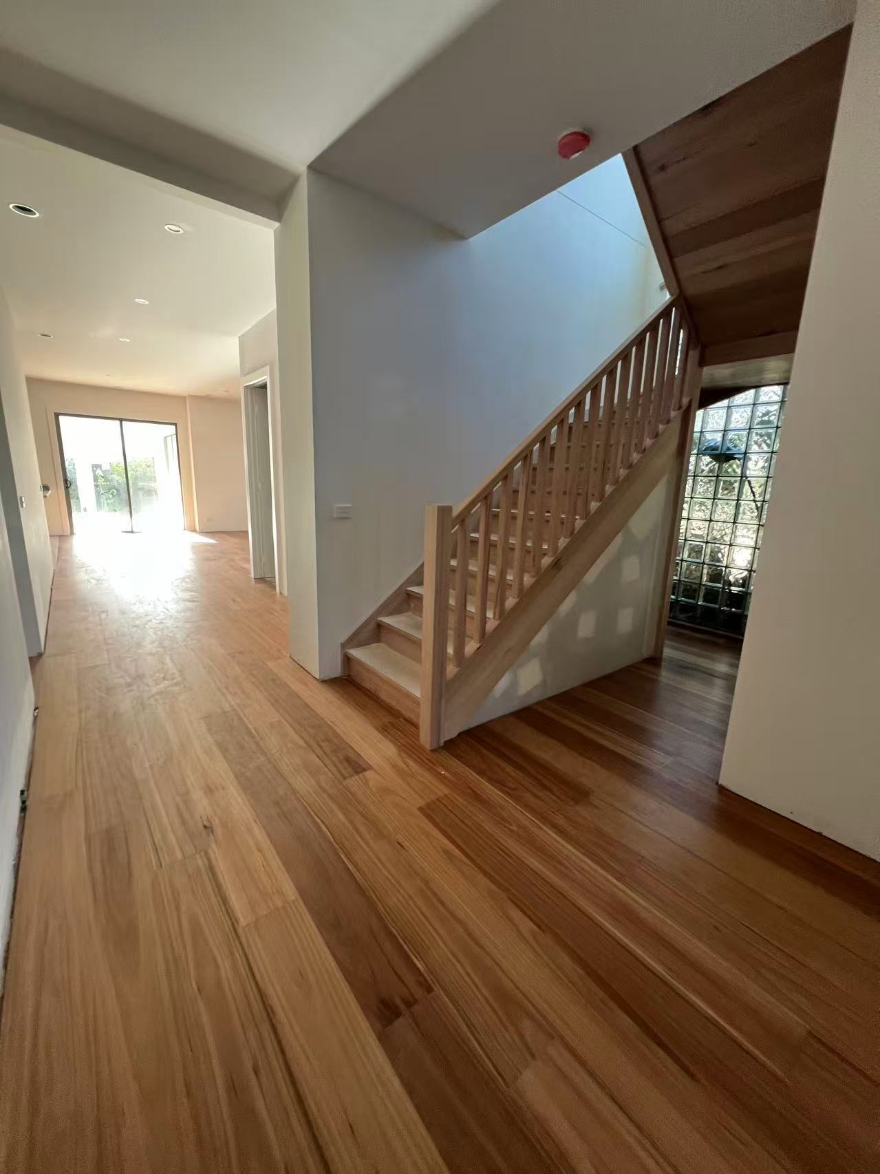 Engineered Blackbutt flooring running through the entry and living area of a Hampton house