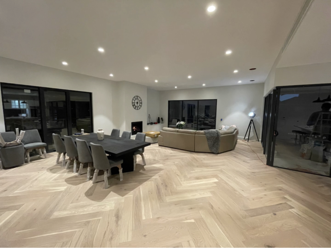 Blonde oak herringbone parquetry flooring in a Wattle Park open plan living and dining room
