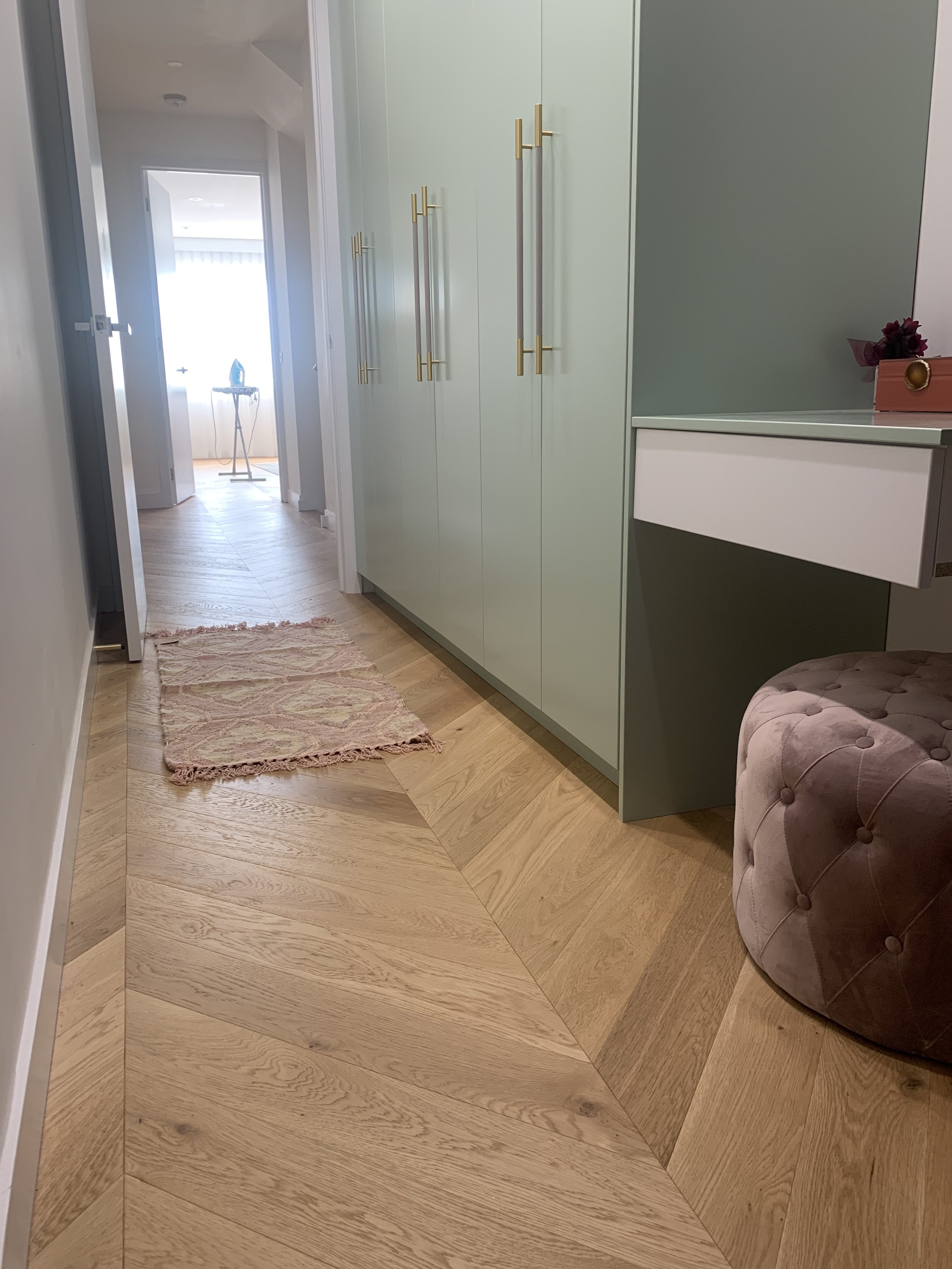 Chevron parquetry flooring with timber border detail in a St Kilda townhouse hallway