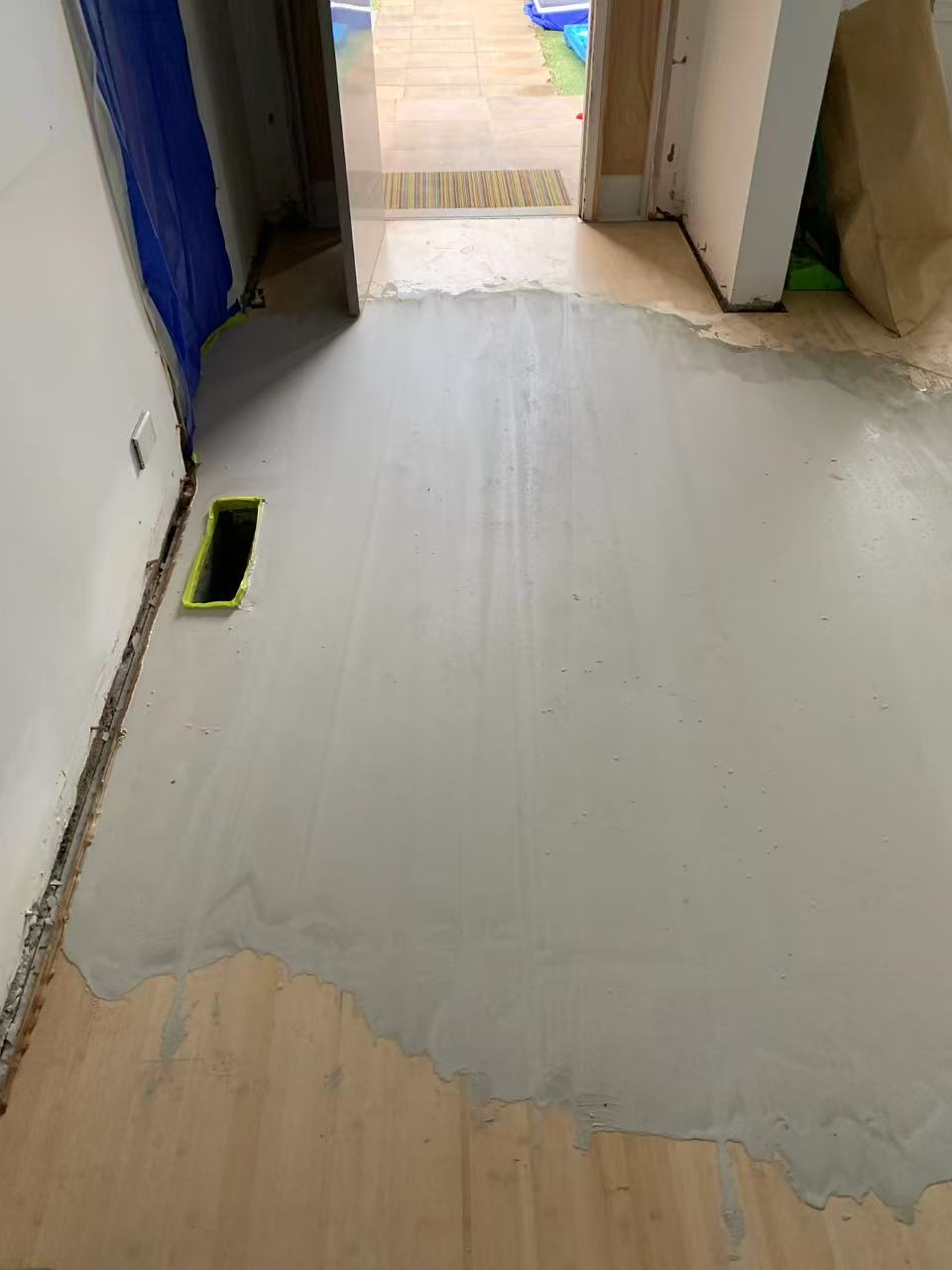 Self-levelling compound poured over an uneven timber subfloor in a Caulfield North home