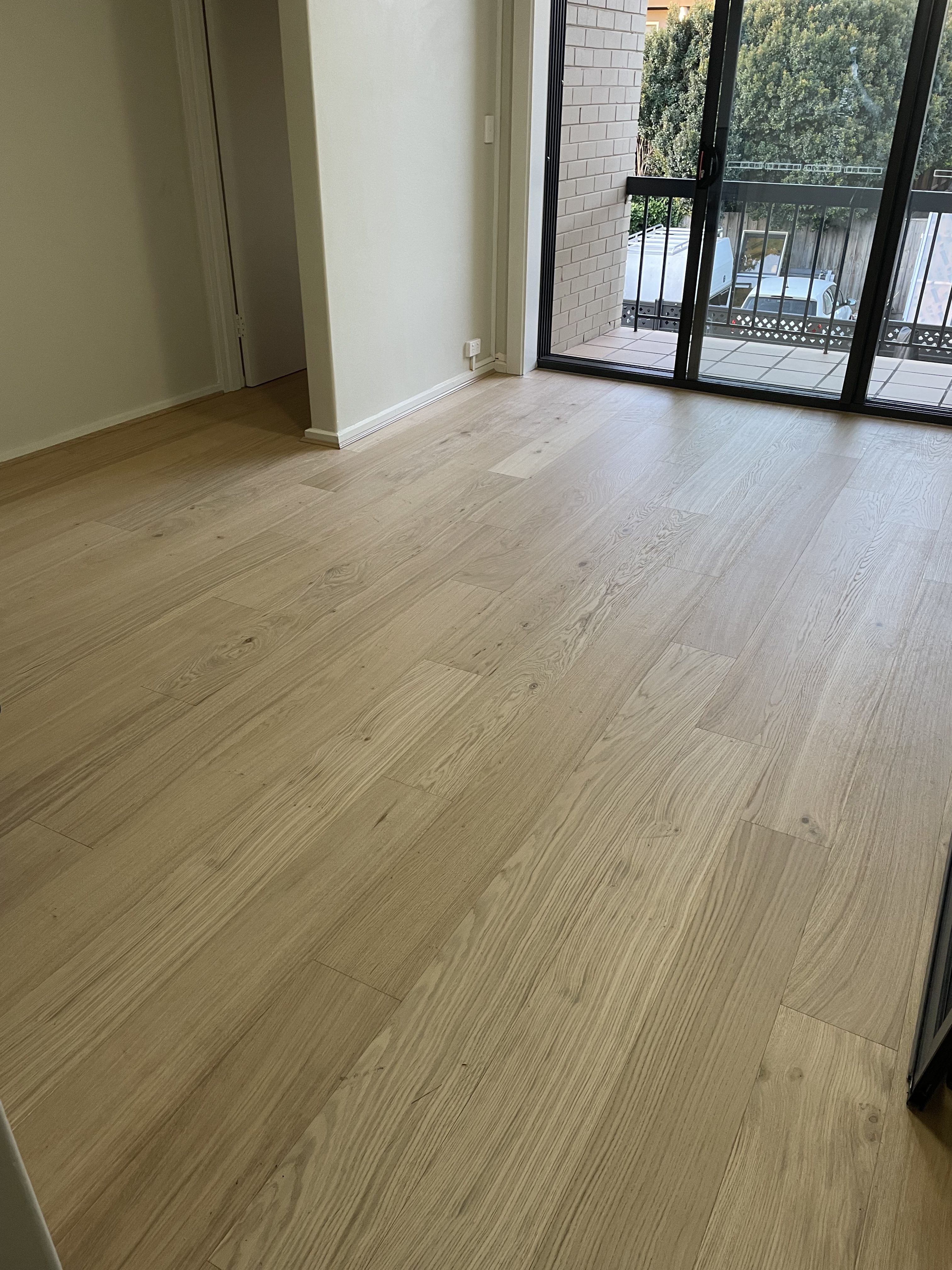 Engineered Sandy Oak flooring in a St Kilda apartment living area with balcony access